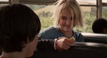Movie still from “Bridge to Terabithia” (2007), directed by Gabor Csupo – A young girl holding an orange in her hand while sitting in the back of a car; Close Up shot, Over the shoulder angle