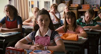 Movie still from “Bridge to Terabithia” (2007), directed by Gabor Csupo – A group of children sitting at a table in a classroom; Close Up shot, Over the shoulder angle
