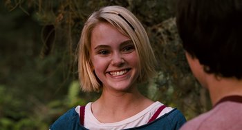 Movie still from “Bridge to Terabithia” (2007), directed by Gabor Csupo – A girl with blonde hair smiles for the camera; Close Up shot, Over the shoulder angle