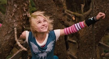 Movie still from “Bridge to Terabithia” (2007), directed by Gabor Csupo – A woman with a colorful arm band is standing next to a tree; Medium shot, Low angle