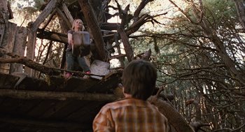 Movie still from “Bridge to Terabithia” (2007), directed by Gabor Csupo – A girl and a boy are standing on a tree branch; Wide shot, Low angle