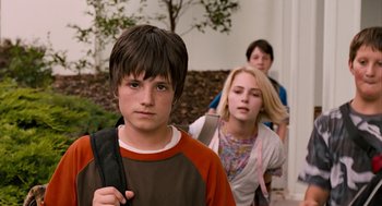 Movie still from “Bridge to Terabithia” (2007), directed by Gabor Csupo – A group of young people walking down a sidewalk; Close Up shot, Over the shoulder angle