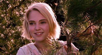 Movie still from “Bridge to Terabithia” (2007), directed by Gabor Csupo – A beautiful young lady standing next to a pine tree; Close Up shot, Over the shoulder angle