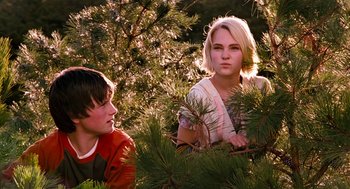 Movie still from “Bridge to Terabithia” (2007), directed by Gabor Csupo – Two young people sitting in a pine tree; Medium shot, Low angle