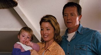 Movie still from “Bridge to Terabithia” (2007), directed by Gabor Csupo – A woman and two men standing next to a baby; Close Up shot, Over the shoulder angle