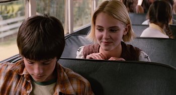 Movie still from “Bridge to Terabithia” (2007), directed by Gabor Csupo – A young girl sitting on a seat next to a young boy; Close Up shot, Over the shoulder angle
