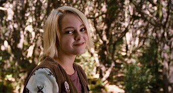 Movie still from “Bridge to Terabithia” (2007), directed by Gabor Csupo – A young blonde haired girl in the woods smiling for the camera; Close Up shot, Over the shoulder angle