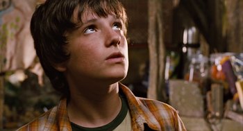 Movie still from “Bridge to Terabithia” (2007), directed by Gabor Csupo – A young man looking up into the sky; Close Up shot, Low angle