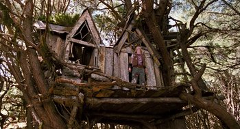 Movie still from “Bridge to Terabithia” (2007), directed by Gabor Csupo – A man standing on top of a wooden structure; Wide shot, Low angle