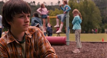 Movie still from “Bridge to Terabithia” (2007), directed by Gabor Csupo – A group of children sitting on top of a play structure; Medium shot, Over the shoulder angle