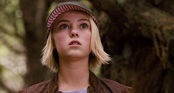 Movie still from “Bridge to Terabithia” (2007), directed by Gabor Csupo – A girl with a hat looking up at the sky; Close Up shot, Low angle
