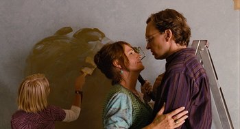 Movie still from “Bridge to Terabithia” (2007), directed by Gabor Csupo – A man and a woman standing next to each other in a room; Medium shot, Over the shoulder angle