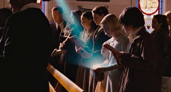 Movie still from “Bridge to Terabithia” (2007), directed by Gabor Csupo – A group of people standing in front of a wooden fence; Medium shot, High angle