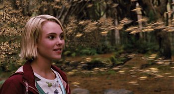 Movie still from “Bridge to Terabithia” (2007), directed by Gabor Csupo – A young blonde haired woman in a forest; Close Up shot, Over the shoulder angle