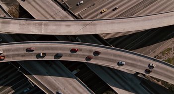 Movie still from “Bridge to Terabithia” (2007), directed by Gabor Csupo – An aerial view of a highway with cars driving on it; Extreme Wide shot, Overhead angle