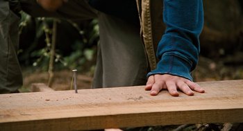 Movie still from “Bridge to Terabithia” (2007), directed by Gabor Csupo – A person holding onto a piece of wood with a nail in it; Extreme Close Up shot, High angle