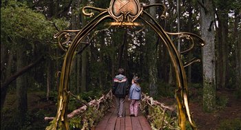 Movie still from “Bridge to Terabithia” (2007), directed by Gabor Csupo – Two people are walking on a wooden bridge in the woods; Wide shot, High angle