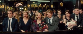 Movie still from “Bridget Jones's Baby” (2016), directed by Sharon Maguire – A group of people sitting next to each other in a room; Medium shot, High angle