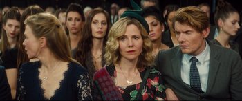 Movie still from “Bridget Jones's Baby” (2016), directed by Sharon Maguire – A group of people that are standing in a room; Close Up shot, Over the shoulder angle