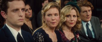 Movie still from “Bridget Jones's Baby” (2016), directed by Sharon Maguire – A woman in a crowd of people wearing a black dress; Close Up shot, Over the shoulder angle
