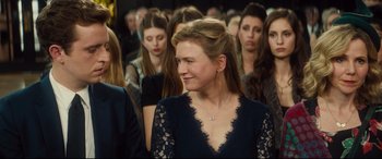 Movie still from “Bridget Jones's Baby” (2016), directed by Sharon Maguire – A group of people standing in a room; Close Up shot, Over the shoulder angle
