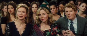 Movie still from “Bridget Jones's Baby” (2016), directed by Sharon Maguire – A group of people that are standing in a room; Close Up shot, Over the shoulder angle