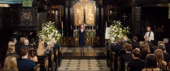 Movie still from “Bridget Jones's Baby” (2016), directed by Sharon Maguire – A woman standing in front of an altar in a church; Wide shot, High angle