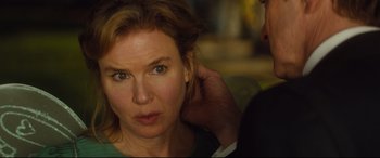 Movie still from “Bridget Jones's Baby” (2016), directed by Sharon Maguire – A woman with her hand on the ear of another person; Close Up shot, Over the shoulder angle