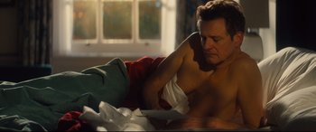 Movie still from “Bridget Jones's Baby” (2016), directed by Sharon Maguire – A man sitting on a bed with a towel on his chest; Medium shot, Over the shoulder angle