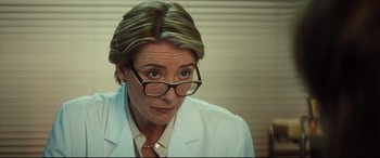 Movie still from “Bridget Jones's Baby” (2016), directed by Sharon Maguire – A woman in a white lab coat and glasses; Close Up shot, Over the shoulder angle