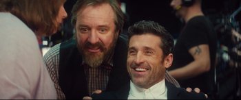 Movie still from “Bridget Jones's Baby” (2016), directed by Sharon Maguire – Two men posing for a picture while wearing suits and bowties; Close Up shot, Over the shoulder angle