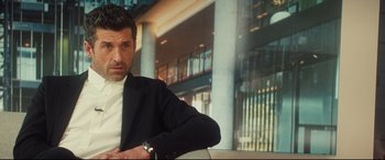 Movie still from “Bridget Jones's Baby” (2016), directed by Sharon Maguire – A person wearing a suit and tie; Close Up shot, Over the shoulder angle