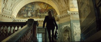 Movie still from “Bridget Jones's Baby” (2016), directed by Sharon Maguire – A woman walking up a flight of stairs in a building; Wide shot, Low angle