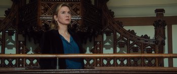 Movie still from “Bridget Jones's Baby” (2016), directed by Sharon Maguire – A woman standing in front of a wooden railing looking off to the side; Medium shot, Low angle