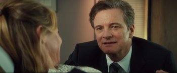 Movie still from “Bridget Jones's Baby” (2016), directed by Sharon Maguire – A person wearing a suit and tie; Close Up shot, Over the shoulder angle