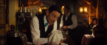 Movie still from “Bridget Jones's Baby” (2016), directed by Sharon Maguire – A man sitting at a table in a restaurant; Medium shot, Over the shoulder angle