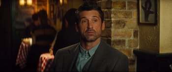 Movie still from “Bridget Jones's Baby” (2016), directed by Sharon Maguire – A person wearing a suit and tie; Close Up shot, Over the shoulder angle