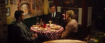 Movie still from “Bridget Jones's Baby” (2016), directed by Sharon Maguire – A man and a woman sitting at a table with plates of food on it; Medium shot, High angle