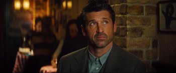 Movie still from “Bridget Jones's Baby” (2016), directed by Sharon Maguire – A person wearing a suit and tie; Close Up shot, Over the shoulder angle