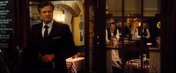 Movie still from “Bridget Jones's Baby” (2016), directed by Sharon Maguire – A man and a woman are standing in front of a table; Medium shot, Over the shoulder angle
