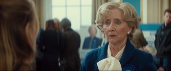 Movie still from “Bridget Jones's Baby” (2016), directed by Sharon Maguire – An older woman in a blue sweater and a white neck tie; Close Up shot, Over the shoulder angle