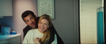 Movie still from “Bridget Jones's Baby” (2016), directed by Sharon Maguire – A man and a woman smiling for the camera; Medium shot, Over the shoulder angle