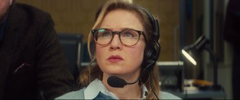 Movie still from “Bridget Jones's Baby” (2016), directed by Sharon Maguire – A woman wearing glasses and a headset looking to her left; Close Up shot, Low angle