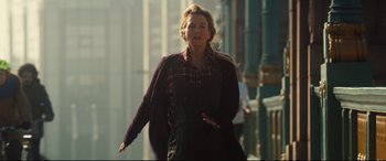 Movie still from “Bridget Jones's Baby” (2016), directed by Sharon Maguire – A woman is walking down the street in the daytime; Medium shot, Over the shoulder angle