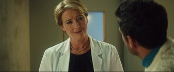 Movie still from “Bridget Jones's Baby” (2016), directed by Sharon Maguire – A woman wearing a white lab coat talking to someone; Close Up shot, Over the shoulder angle