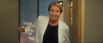 Movie still from “Bridget Jones's Baby” (2016), directed by Sharon Maguire – A woman in a white jacket smiling for the camera; Medium shot, Low angle