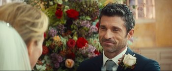 Movie still from “Bridget Jones's Baby” (2016), directed by Sharon Maguire – A person wearing a suit and tie; Close Up shot, Over the shoulder angle