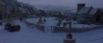 Movie still from “Bridget Jones's Diary” (2001), directed by Sharon Maguire – A cemetery with a wreath on top of it in the middle of the snow; Extreme Wide shot, High angle