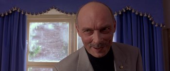 Movie still from “Bridget Jones's Diary” (2001), directed by Sharon Maguire – A man with a mustache and a beard; Close Up shot, Low angle