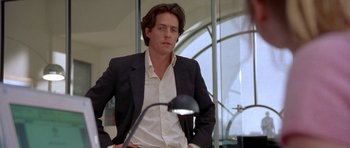 Movie still from “Bridget Jones's Diary” (2001), directed by Sharon Maguire – A man wearing a suit and white dress shirt; Close Up shot, Over the shoulder angle